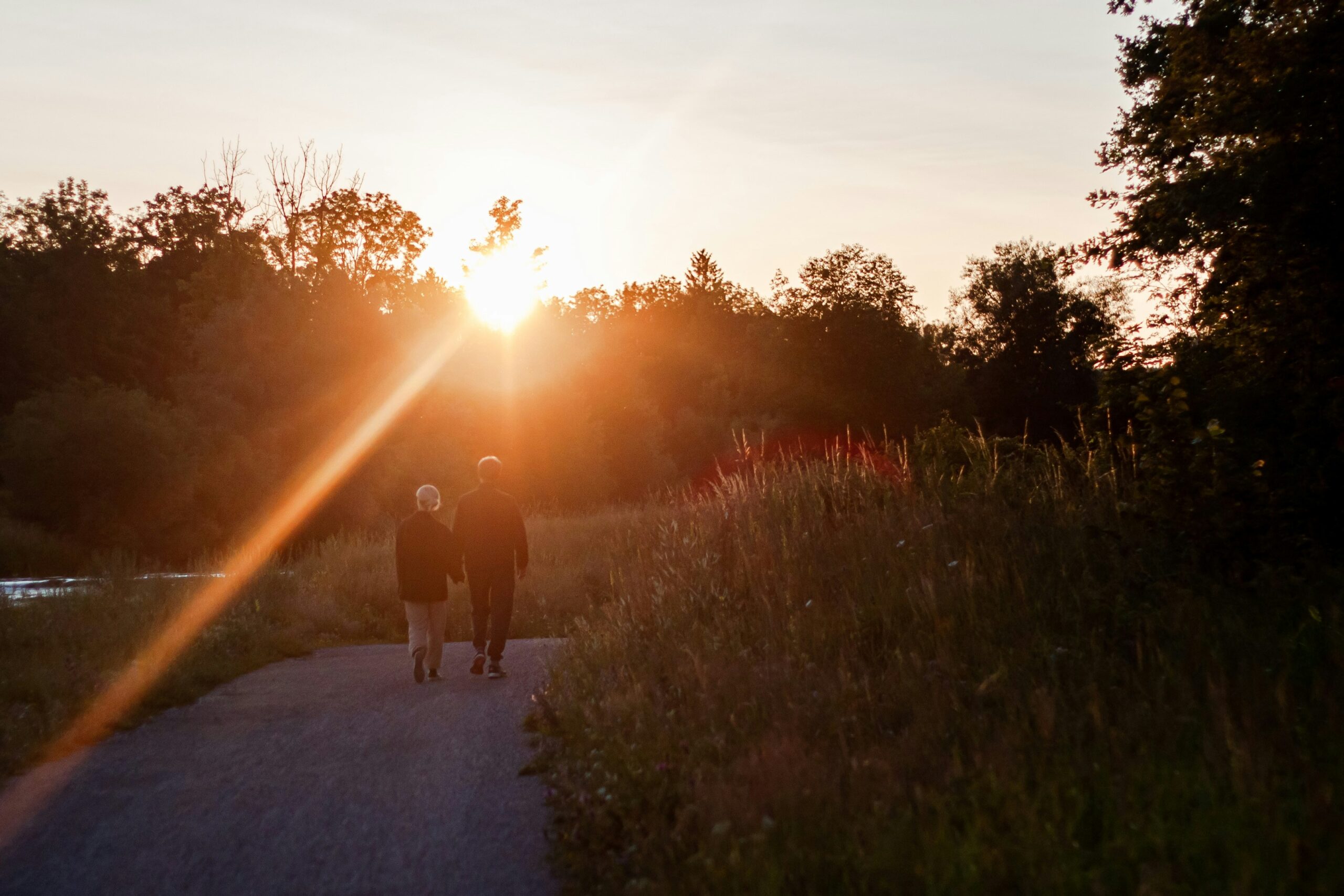 elderly couple walking at sunset